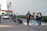 Se observan estudiantes a fuera del Poliforum León caminando y sentados